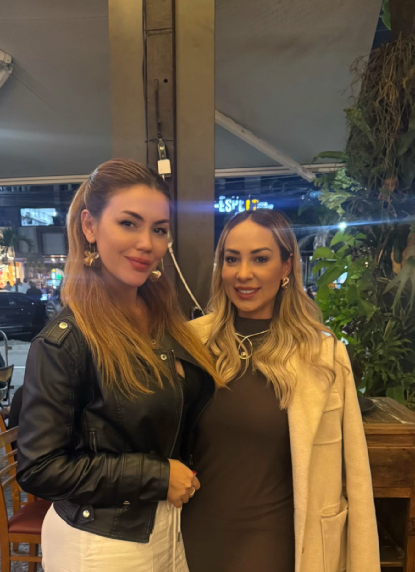 Mariane Nunes, empresária brasileira em Dubai, em conversa com outra mulher em restaurante
