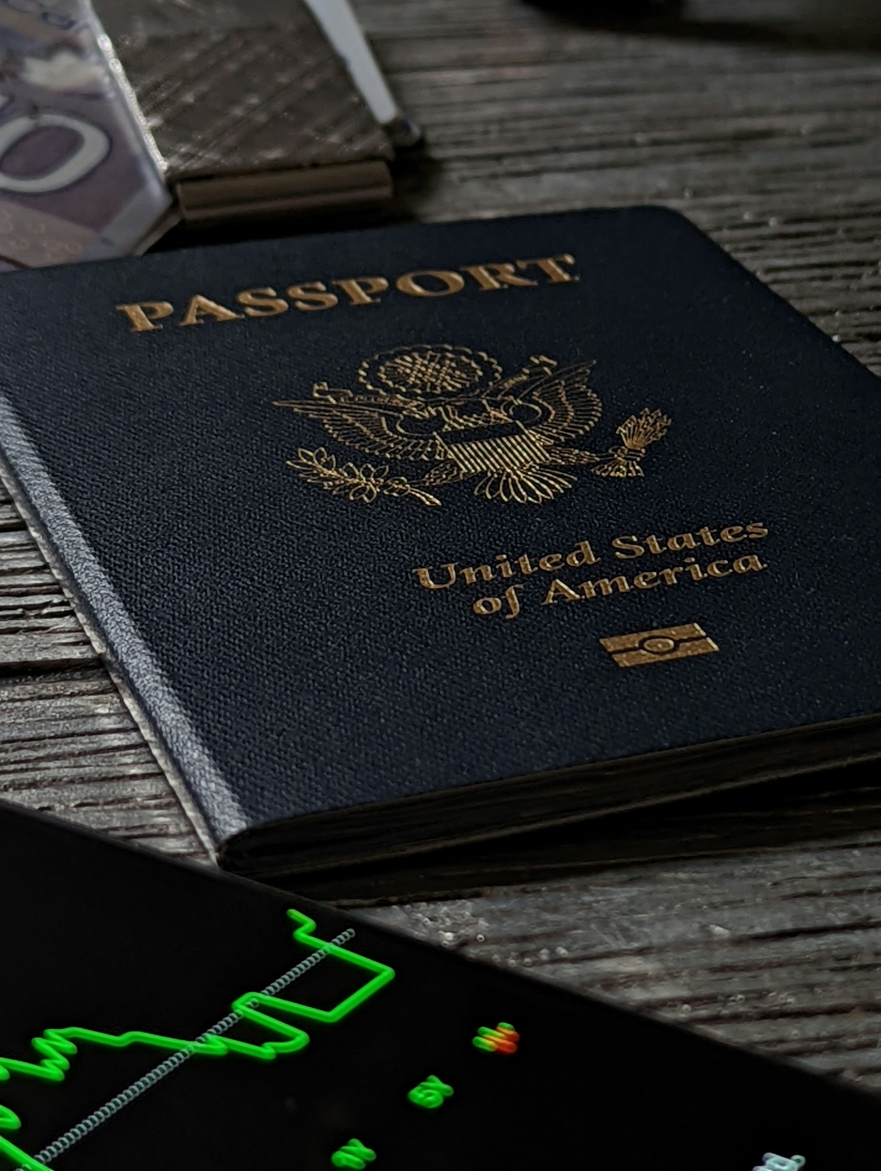 Passaporte apoiado sobre mesa de madeira com documentos de viagem.